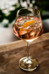 rose wine spritzer with orange cocktail drink on table outside - 390130184
