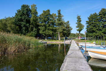 A floating jetty and boats in a lake. Picture from Ringsjon, Scania county, Sweden