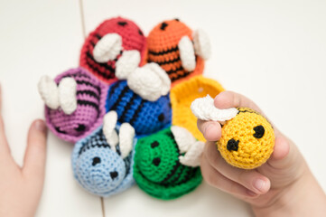 Colorful beehive with bees. Crochet safe toys for babies. Processed egg craft ideas are a bright Easter-colored rainbow-colored educational toy. Preschool game for young children. Montessori education