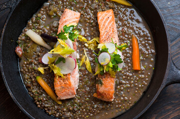 Salmon steaks. Salmon sautéed in organic butter, garlic and served with jumbo lump crab cake, cauliflower, broccoli and potatoes. Classic American restaurant or French bistro entree favorite.