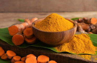 Turmeric (curcumin) and powder on wooden background,For cooking and as a Thai herbal medicine,spices.