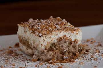 Tiramisu Dessert. Classic Italian dessert. Lady fingers soaked in syrup, espresso and layered with cream, nuts and powdered sugar.