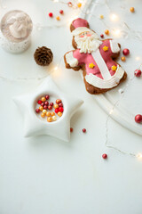 Fototapeta na wymiar Tasty icing Christmas cookies on white table. Traditional Xmas gingerbread cookies