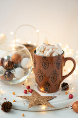 Christmas hot chocolate with marshmallow and gingerbread cookies on white wooden table. Traditional hot drink at Christmas.