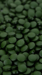 superfoods Spirulina, chlorella supplement pills close up, macro shot