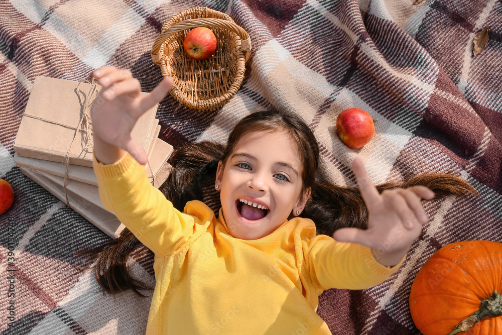 Canvas Prints Cute little girl lying on plaid in autumn park