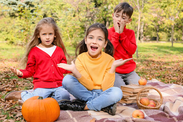 Fototapeta premium Cute little children having picnic in autumn park