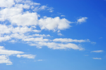 Bright white clouds against the blue sky. Transparent elongated clouds.