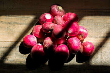 bunch of fresh radish on a wooden background