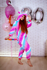 birthday girl in rainbow pajamas with balloons and cake 30 years old