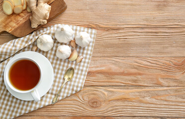 Cup of healthy garlic tea on table
