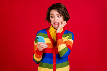 Photo of beautiful terrified lady hold telephone frightened bite fingers read negative bad news...