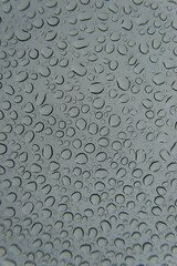 Gouttes de pluie sur une vitre un jour de temps gris