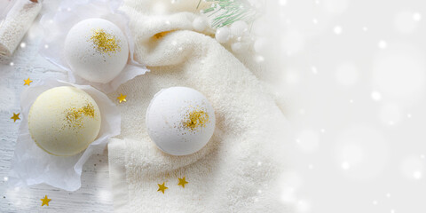Composition with bath bombs on white towel. Spa concept,  wellness, body care cosmetic treatment. Greeting card for Mothers day, Christmas or wedding. Banner.