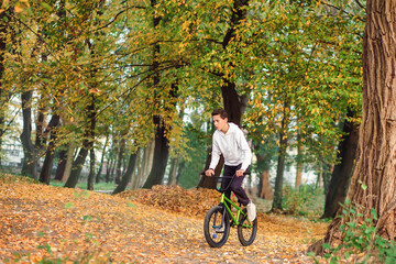 Park , a boy teenager rides a bike. Extreme sport.