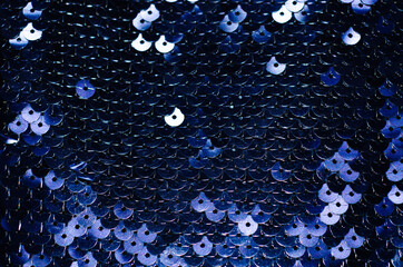 Abstract blue texture. Elegant fabric in the art Deco style with round blue sequins.