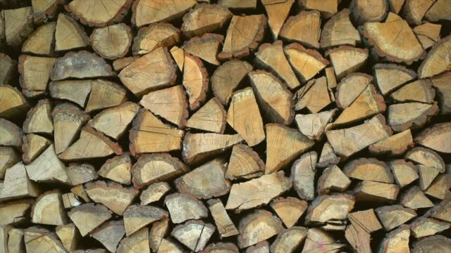 Logs stack texture, log background. Wood, chopped firewood. Closeup video, slow motion