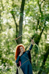 cosplay Brave red curly girl with a bow in the woods
