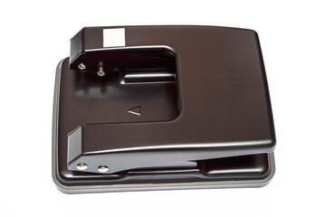 Black office hole punch on white background. Top view
