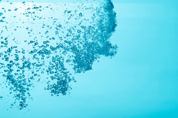Close up of a water and air bubble on blue background.