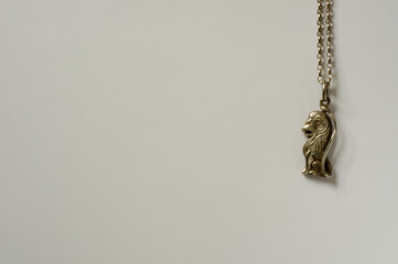 Silver lion pendant with chain on white background with copy space