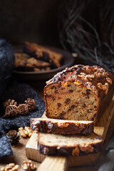 Delicious homemade chocolate and walnut gluten free banana bread sliced on wooden bread