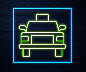 Glowing neon line Taxi car icon isolated on brick wall background. Vector.