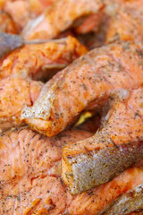 Grilled red fish trout steaks lie on a glass plate