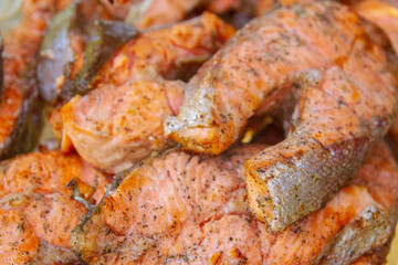 Grilled red fish trout steaks lie on a glass plate
