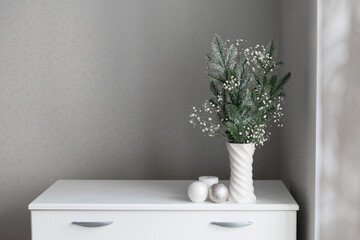 new year decor minimalistic composition of fir tree branches and gypsophila in vase