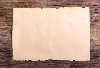 Old paper on a wooden table close up