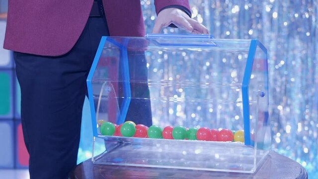 Plastic balls are mixed in a bingo drum. the drawing of prizes using a Lotto.