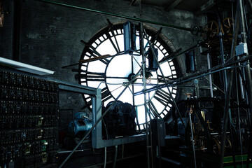 Interior of old big tower clock face mechanism inside brick space - Powered by Adobe