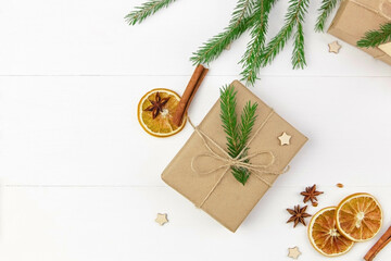 Obraz na płótnie Canvas Christmas gift box decorated with fir tree branch with spices