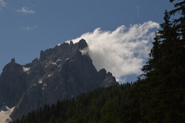 Hiking in the lush and dramatically beautiful Val di Fiemme and Passo Rollo in the Dolomites,...