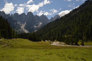 Fototapeta na wymiar Hiking and climbing in the stunning valleys and mountains of Val di Fiemme in the Dolomites, Italy