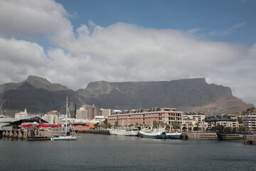 Fototapeta na wymiar View of Victoria and Alfred Waterfront with table mountain under blue sky at Table Bay Harbour in Cape Town, South Africa