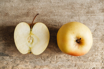 Two yellow apples on an old wooden background. Top view. Copy, empty space for text