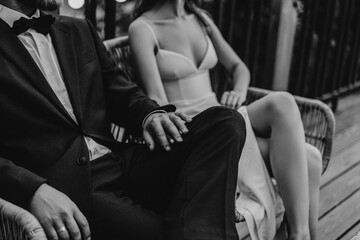 The groom in a suit hugs the bride in a wedding dress