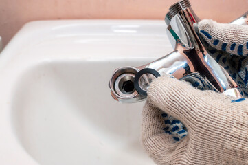 Installing the seal in the water mixer during faucet maintenance