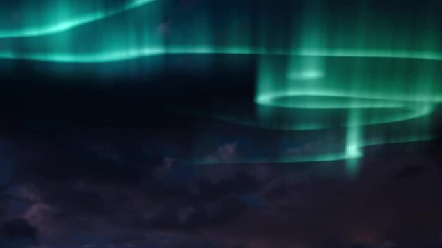 Animation of aurora borealis glowing trails in blue and green over clouds and sky at night