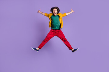 Fototapeta na wymiar Photo portrait full body view of man spreading arms legs like star jumping up isolated on vivid purple colored background