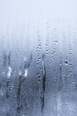 Raindrops on window glass. Abstract background. Blue tone