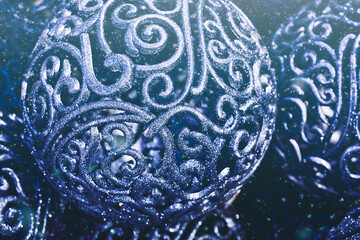 Christmas background with blue ornament balls closeup. Winter holiday xmas and Happy New Year theme. Snow texture.