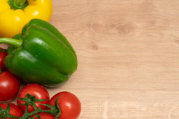 Yellow and green bell peppers and tomatoes with copyspace