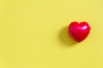 Red heart ball with yellow paper background for love concept, and wedding or Health care.