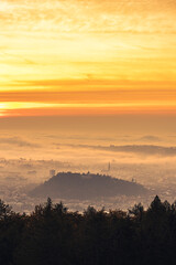 Graz city covered if fog on autumn morning during sunraise.