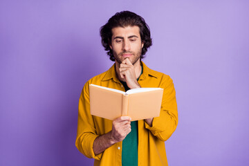 Photo of young brown hair man red book serious focused hand touch chin isolated over purple color...