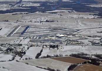 Aerial view of the Brantford Municipal airport in southern Ontario, view of the runways and hangars, light snow cover on the ground, Canada
