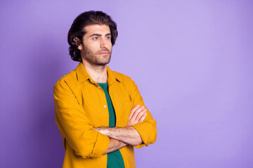 Photo of young confident multiethnic man folded hands look empty space isolated over purple color background